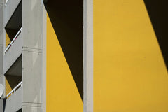 Marcus Lenk - Minimalist architectural photo showcasing bold yellow walls and contrasting shadows.