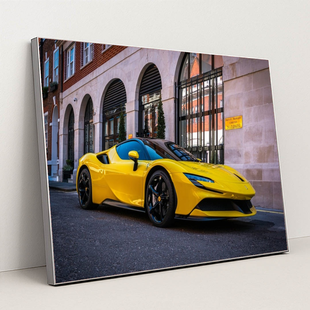 This photo shows a yellow Ferrari SF90 Stradale parked on the street in front of elegant city buildings, in a silver frame.