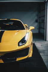 Ferrari 488 Pista in Giallo Modena showcased in the garage, emphasizing its vibrant yellow color and sleek design, perfect for car wall art.